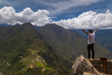 Traveller at the Lost city of the Incas, Machu Picchu,Peru on top of the mountain, with the view panoramic.