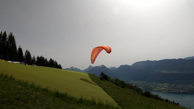 Paragliders with parapente jumping of Col de Forclaz near Annecy in French Alps, in France.