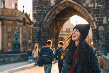 woman portrait at sunrise at charles bridge in prague