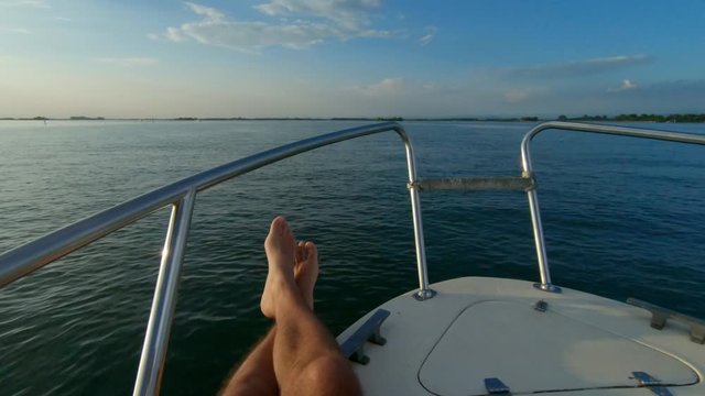 Man relaxing on a boat in the Grado Lagoon, Italy