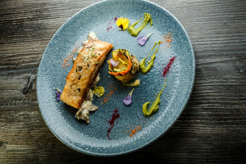 top view on grilled sea fish steak served on fried mushrooms