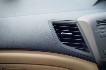 Obraz na płótnie Canvas Car air conditioner grid panel on console Close up