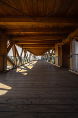 Fototapeta premium langer offener Gang eines Gebäudes in sichtbarer Holzkonstruktion