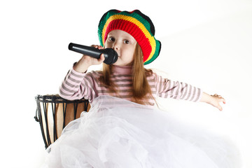 Fun rastafarian toddler girl sinnging in a microphone
