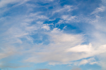 Naklejka na ściany i meble White clouds on a background of blue sky on a sunny day. Summer season, august.