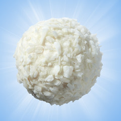Sweets made of white creamy chocolate in coconut on a soft blue background. Full sharpness.