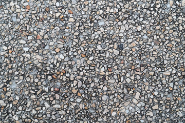 Grunge pebble floor as seamless textured background.Small pebbles mixed with sand texted background.