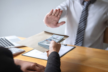 Anti bribery and corruption concept, Business man refusing and don't receive money banknote in...