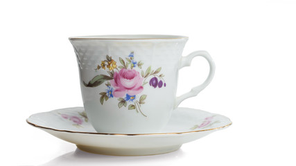 Porcelain white cup on a saucer with gilding. Isolated on a white background