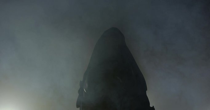 Silloutte Of Blonde Female Boxer Wearing Boxing Robe In Smoke. Preparing To Go Out And Fight. Looking Up At Her Supporters. Before A Fight , Lit By Studio Lights Behind Her.