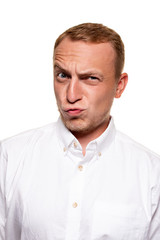 Fototapeta premium Handsome young blond man in a white shirt, isolated on a white background