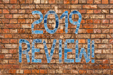 Conceptual hand writing showing 2019 Review. Concept meaning remembering past year events main actions or good shows Brick Wall art like Graffiti motivational call written on the wall