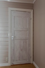 View of white interior door primed with white color before to be painted. Painting concept.