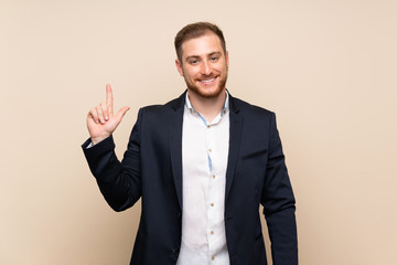 Blonde man over isolated background showing and lifting a finger in sign of the best