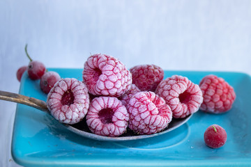 Frozen berries of red raspberries on the boat