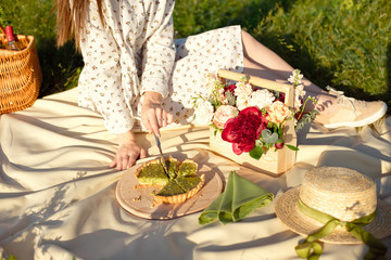 Naklejka na ściany i meble Picnic set with fruit, cheese, toast, honey, wine with a wicker basket and a blanket. Beautiful summer background with girl and products on nature