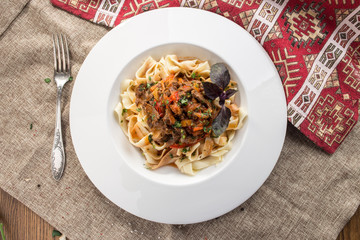 spicy hungarian beef with vegetables in sauce served with fettuccine on tablecloth