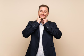 Blonde man over isolated background smiling with a happy and pleasant expression