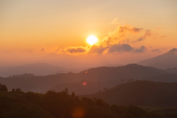 Selective focus of the sunrise over mountain in the morning with clouds. Landscape of the sun with clouds in the summer.