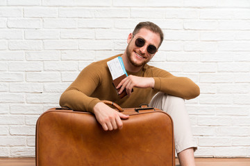 Traveler man with suitcase and boarding pass