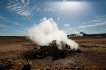 A wide angle view of icelandic volcanic landscape.Steam pours out of a steam vent in both the foreground and distance - Image