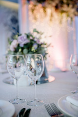 Beautiful festive table setting with elegant white flowers and cutlery, dinner table decoration