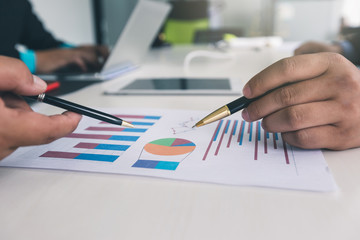 Businessmen discussing together in meeting room. Business team meeting and discussing project plan. Professional investor working with business project together. Finance managers task.