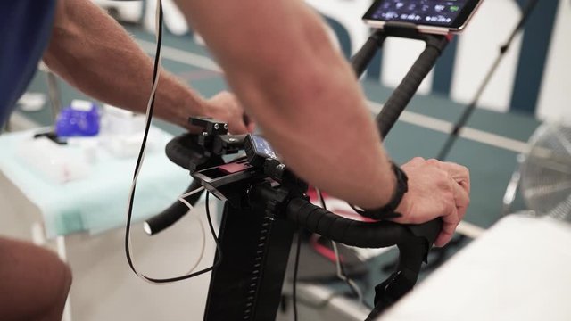 Professional triathlete cycling in sport science lab at testing