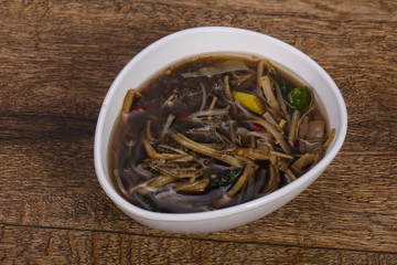 Thai style soup with meat and mushrooms