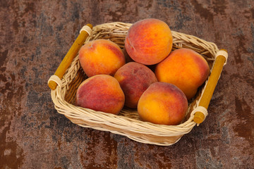 Peach heap in the wooden basket