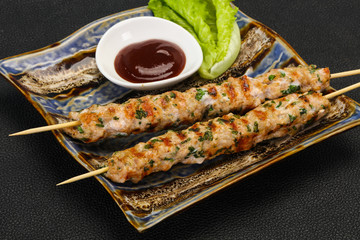 Minced pork skewer kebab with sauce