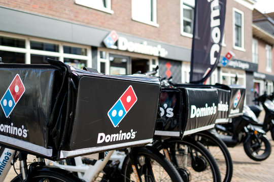 KATWIJK AAN ZEE, THE NETHERLANDS - June 18, 2018: Delivery bikes of Domino's restaurant. Domino's is an American pizza restaurant chain founded in 1960.