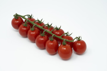 a bunch of tomatoes fruits on a white background