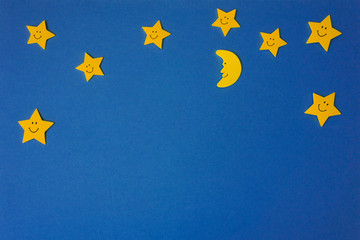 Crescent moon and yellow stars against the blue night sky. Application paper. Copy space