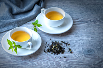 two cups of green tea on a gray background