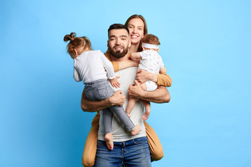 happy positive family posing to the camera. parenthood, relationship. close up photo.isolated blue background. feeling and emotion. friendship - 284001134