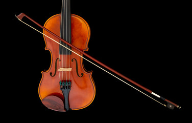 Child's violin with bow isolated on black background