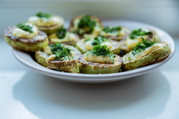 homemade zucchini fried with mayonnaise. On a white background