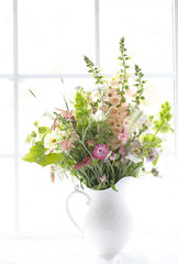 Original high key photograph of a bouquet of wildflowers against a white window with grids