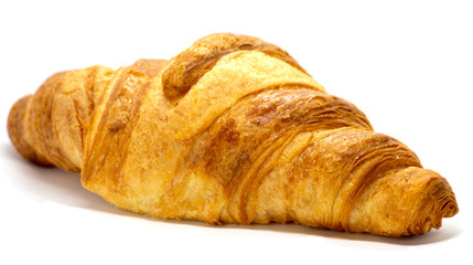 Freshly baked croissant with flaky texture on white background. 