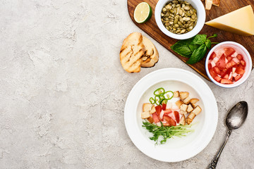 top view of fresh ingredients in plate and on wooden cutting board