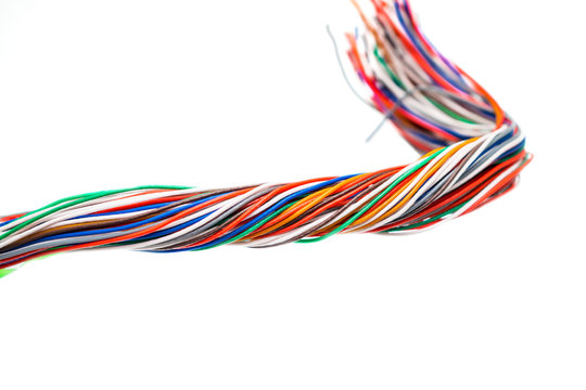 Plait of multicolored electrical wires isolated on white background. Many twisted pair cables are intertwined