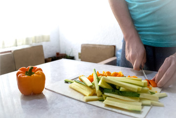 Young man cut vegetables table Mesa verduras hombre joven 