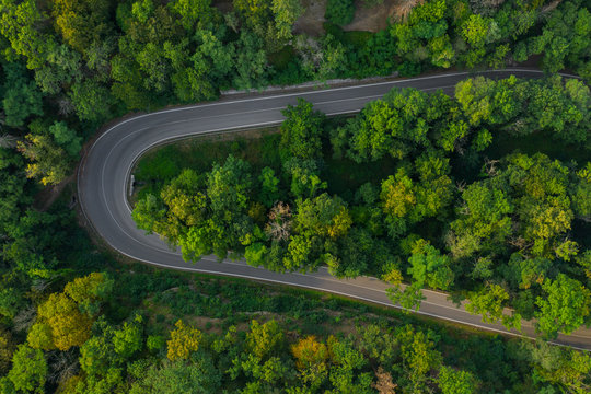 Aerial View of a Highway Road in the Mountain Near the City © vladim_ka