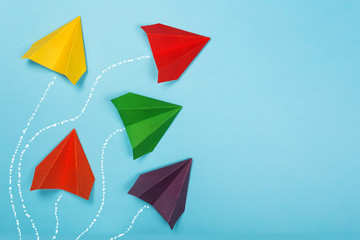 Color paper airplanes on blue background. Different vision creative and Innovative solution for Business concepts.
