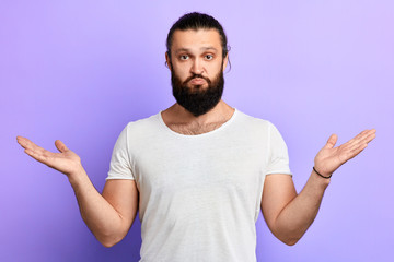 Fototapeta premium serious strong muscular man showing welcome gesture, greeting people, close up portrait, isolated blue background