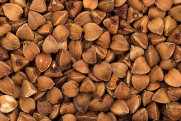Macro Photo food buckwheat groats. Texture background grain buckwheat groats. Image food product porridge buckwheat grains