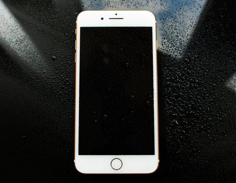 PARIS, FRANCE - SEP 26, 2016: New Apple iPhone 7 Plus under rain waterdrops. New iPhone7 is one of the best waterproof smartphone in the world