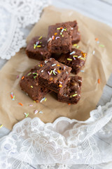 Banana brownies with multi colored sprinkles, crinkled parchment paper, lace fabric