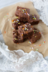 Banana brownies with multi colored sprinkles, crinkled parchment paper, lace fabric
